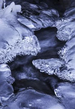 Beautiful patterns of ice are formed when water continues running as a stream fr Stock Photos