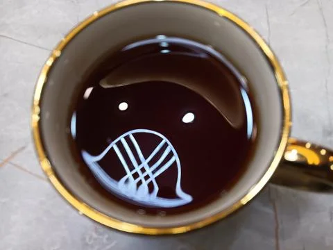 Beautiful patterns reflected on a cup of tea. Coincidence. Stock Photos