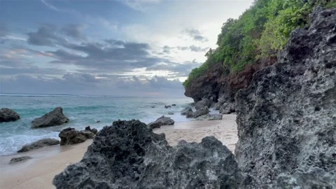 Beautiful peaceful landscape with ocean waves and dark rocks at blue hour. Wild Stock Footage 169920366