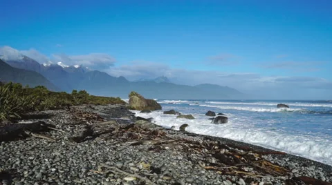 Beautiful pebble beach with mountains in background Stock Footage 65077001