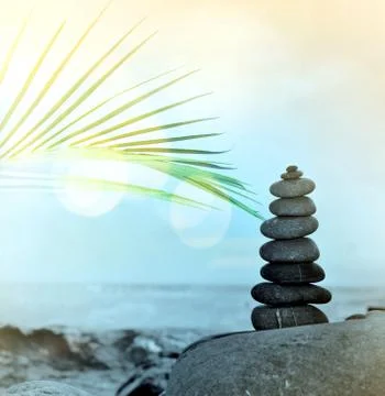 Beautiful pebble stack on a sandy beach Stock Photos