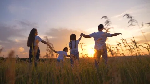 Beautiful people raise their hands up to the sun at sunset. Leisure healthy Stock Footage 136121991