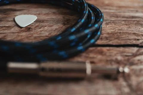 Beautiful photography of a P10 cable and a guitar pick. Stock Photos