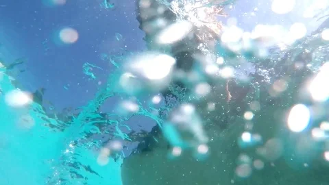 Beautiful pictures of young man playing in the pool, submerged with many bubbles 動画素材 106310341