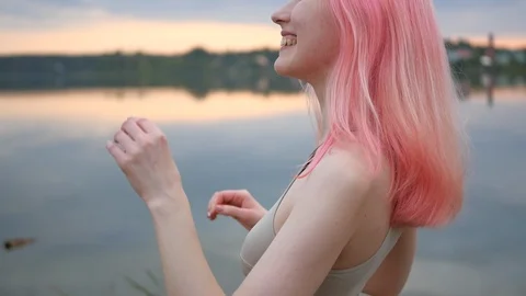 Beautiful pink haired model posing in swimsuit at sunset. Stock Footage 100604112