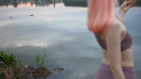 Beautiful pink haired model posing in swimsuit at sunset. Stock Footage 100605115