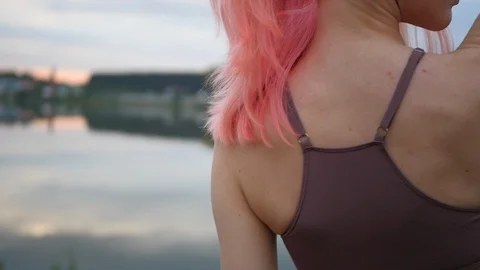 Beautiful pink haired model posing in swimsuit at sunset. Stock Footage 100605591