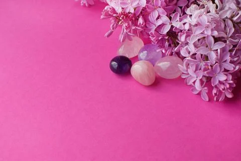 Beautiful pink lilac flowers and semi-precious stones, rose quartz and amethy Stock Photos