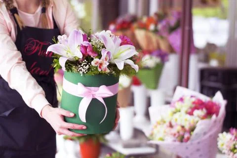 Beautiful pink lilies in a gift box. Bouquet of flowers with lilies. Stock Photos