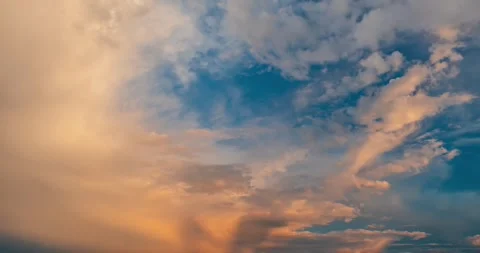 Beautiful pink sunset clouds with small moon appearing in blue sky time lapse Stock Footage 340549450