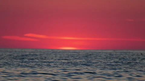 Beautiful pink sunset over calm sea, relaxing waves and soft light, romantic 4K Stock Footage 334318258