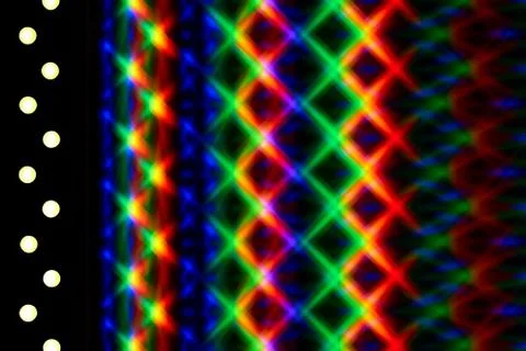 Beautiful play of light from intersecting brightly colored rainbow light spots Foto stock