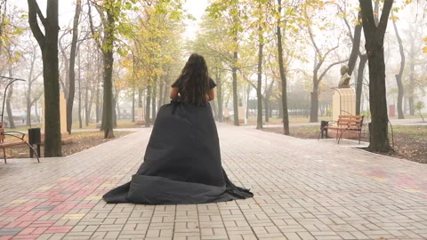Beautiful plus size model in black long amazing dress at the park Stock Footage 110850210