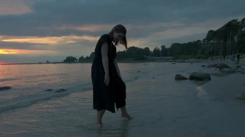 Beautiful plus size model is walking on Pirita beach by the Baltic Sea Stock Footage 139690470