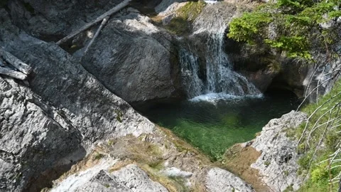 A beautiful pool of a mountain stream with waterfalls (slow motion) 스톡 동영상 219644162