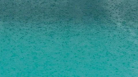 Beautiful pool water surface under the rain. Slow motion Stock Footage 63178087