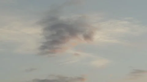 A beautiful pre-sunset sky with light cumulus clouds painted in soft golden Stock Footage 337837569