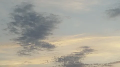 A beautiful pre-sunset sky with light cumulus clouds painted in soft golden Stock Footage 337837573