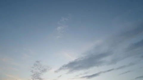 A beautiful pre-sunset sky with light cumulus clouds painted in soft golden Stock Footage 337837597