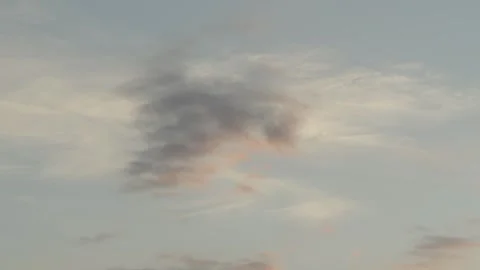 A beautiful pre-sunset sky with light cumulus clouds painted in soft golden Stock Footage 337838333