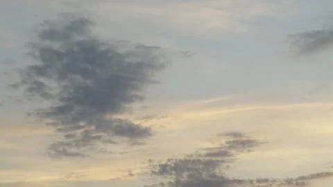A beautiful pre-sunset sky with light cumulus clouds painted in soft golden Stock Footage 337838445