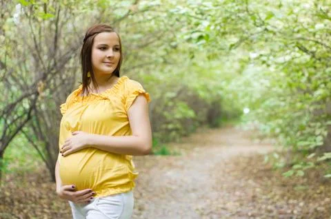 Beautiful pregnant woman in the park Stock Photos