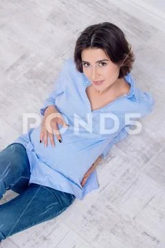 A beautiful pregnat woman sitting in a studio. Motherhood. Fashion for pregna Stock Photos