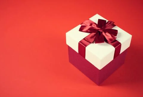 Beautiful present box on red background. Stock Photos