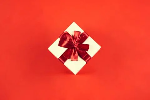 Beautiful present box on red background. Stock Photos
