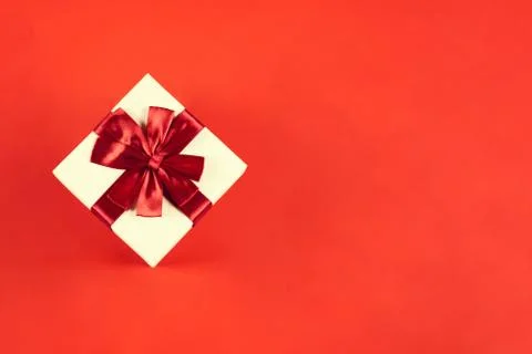 Beautiful present box on red background. Stock Photos