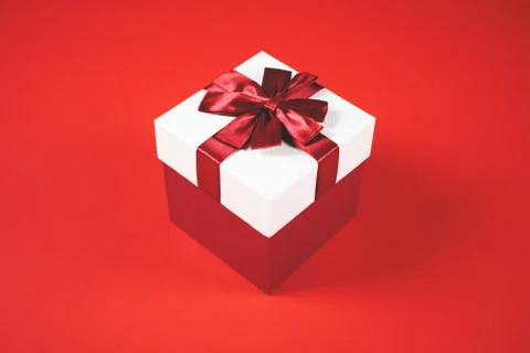 Beautiful present box on red background. Stock Photos
