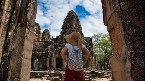 Beautiful, pretty, young Thai girl is exploring the ancient ruins of Angkor W Stock Photos