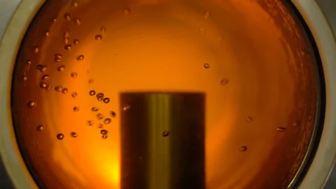 Beautiful process of filtering beer in the window. Close-up. Slow Motion. Stock Footage 129540996