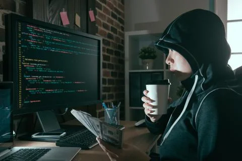 Beautiful programmer hacker drinking hot coffee 스톡 사진