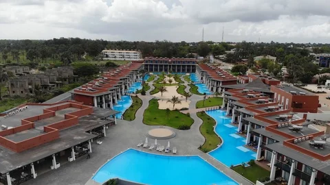 Beautiful Pull out from a Resort with Pools to the Ocean Stock Footage 118387501