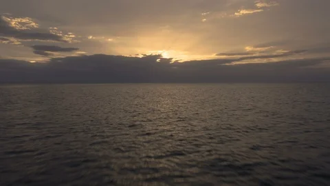 Beautiful push forward over ocean, tilt up reveals classic sunset  Stock Footage 112696600