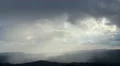 Beautiful rainy dawn in mountains, sunlight rays shining through cloudy sky HD Footage