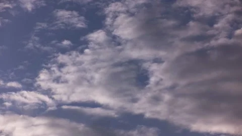 Beautiful rare gray clouds float in the blue sky. Time laps. Stock Footage 142078923