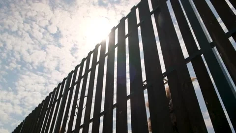 A beautiful ray of the sun sparkles through the fence boards in the restaurant Stock Footage 261431901