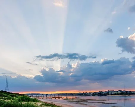 Beautiful rays of light protruding from clouds above Phillip Island Bridge .. Stock Photos