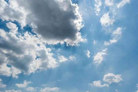 Beautiful rays of light in the sky from behind the clouds Stock Photos