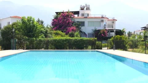 Beautiful rectangular pool with blue turquoise water and private house villa Stock Footage 130515225