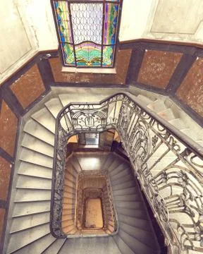 Beautiful rectangular spiral staircase with black railings and part of amazin Stock Photos