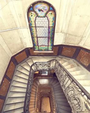 Beautiful rectangular spiral staircase with black railings and amazing staine Stock Photos