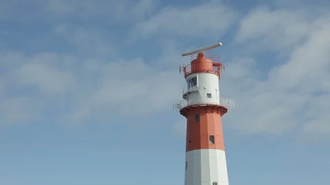 Beautiful red and white lighthouse with radar Stock Footage 88147608