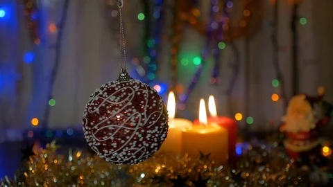 A beautiful red ball rotates in the foreground. New Year and Christmas Video stock 82499096