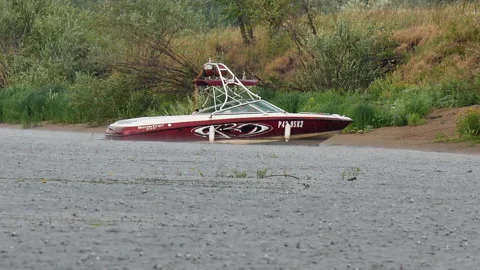 A beautiful red boat is moored to the shore. Stock Footage 188281153
