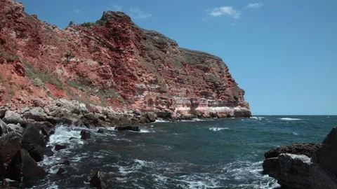 Beautiful red cliffs edging the coastline of Bulgarian Black Sea, rocky canyon Stock Footage 70572821