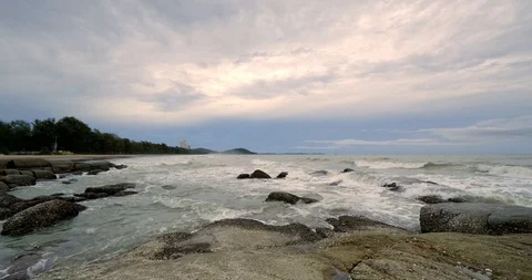 Beautiful red cloudy sky and danger sea wave crashing on rock coast Stock Footage 109559324