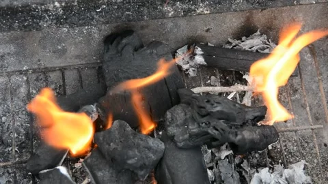 Beautiful red fire from dark grey black coals inside metal brazier.  Stock Footage 130372496
